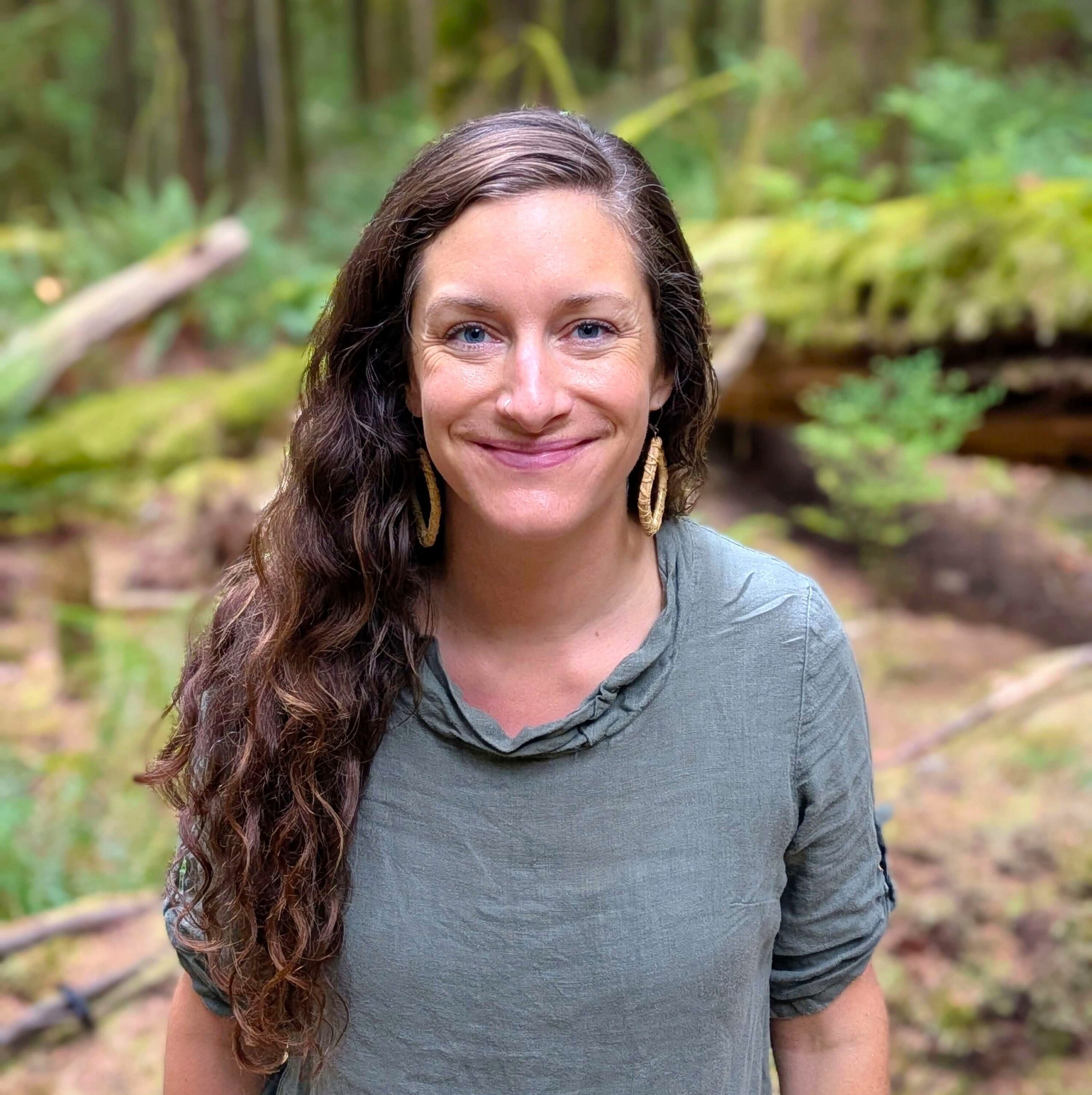 Gemma smiling in the forest